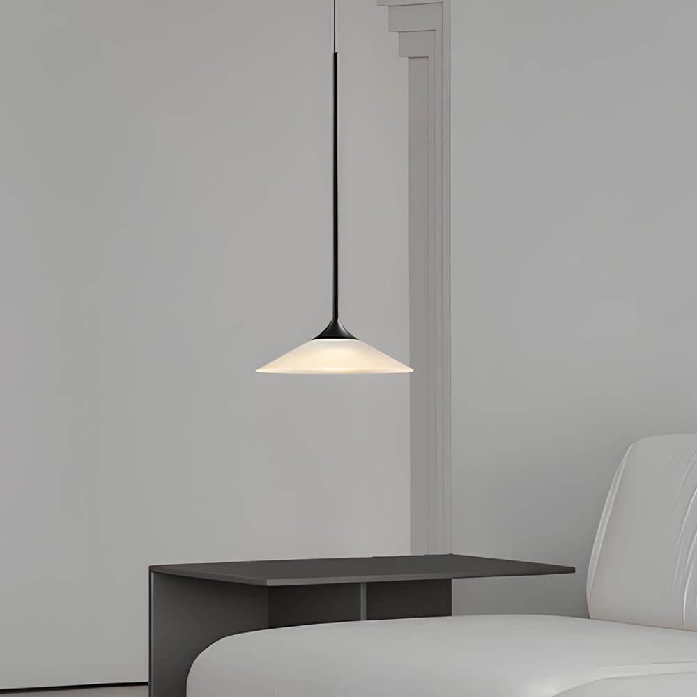 Aureon conical pendant light hanging in a minimal bedroom interior