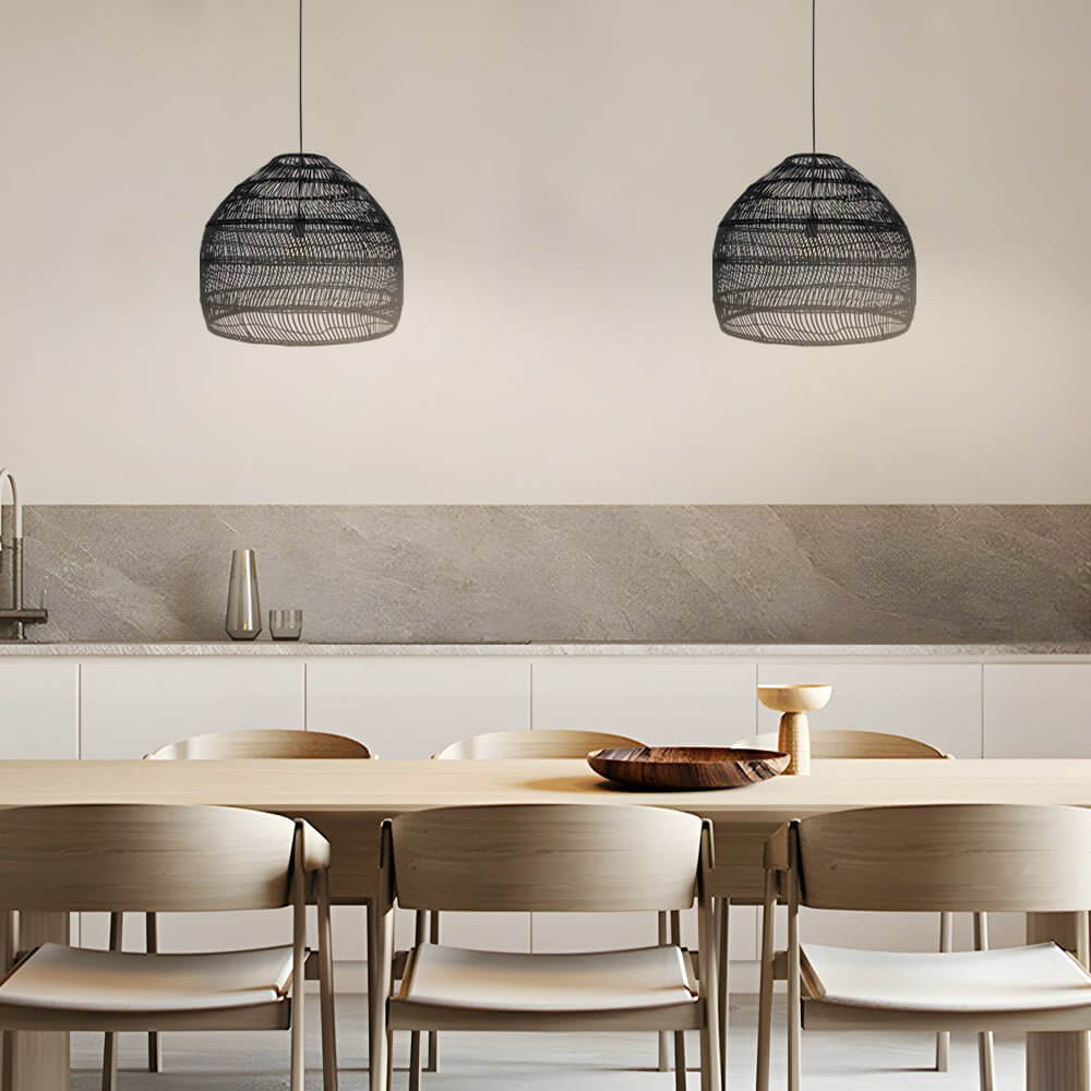 Aureon woven rattan dome pendant light with black metal fitting hanging above a dining table