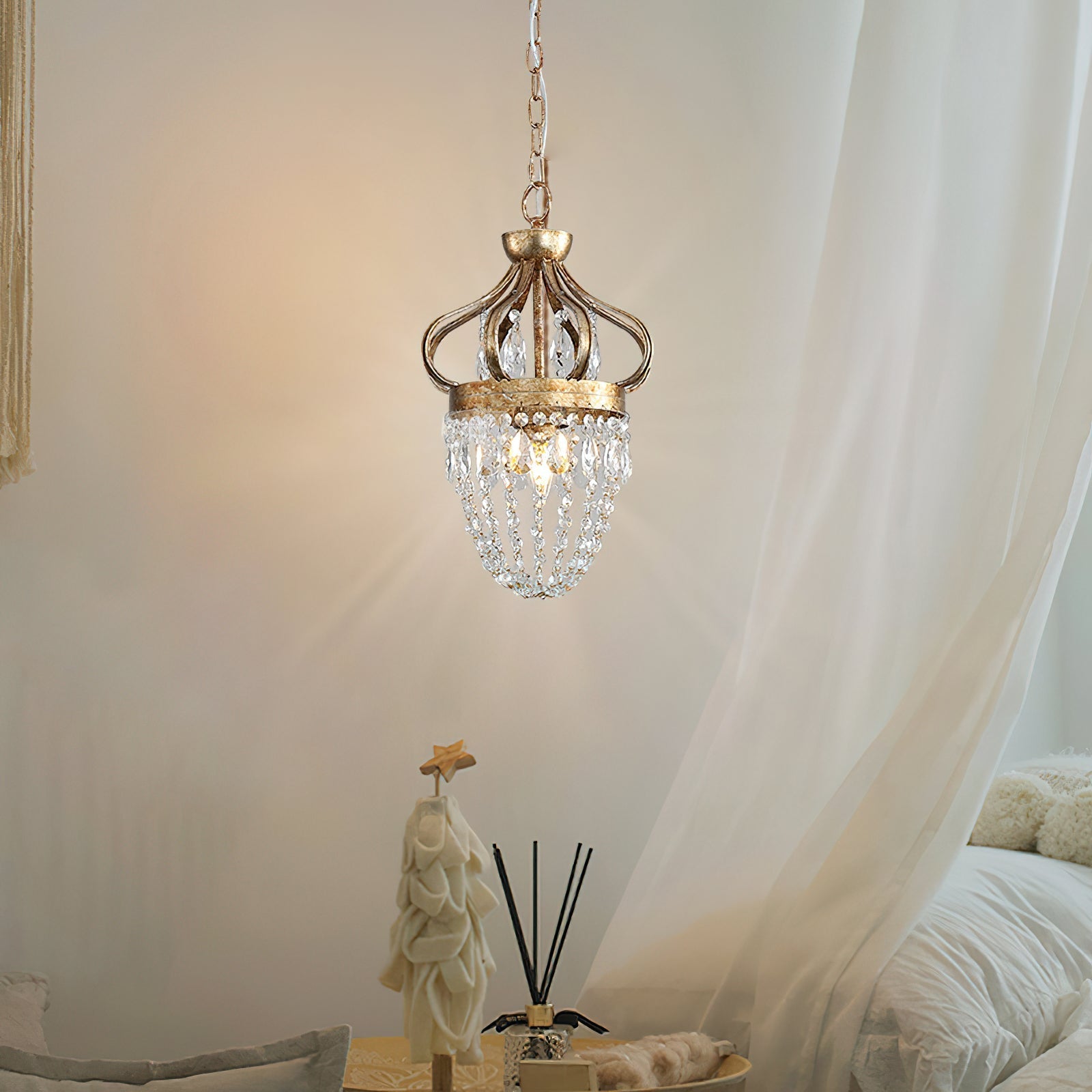 Antique silver crystal chandelier lit in a modern hallway, warm glow through glass drops