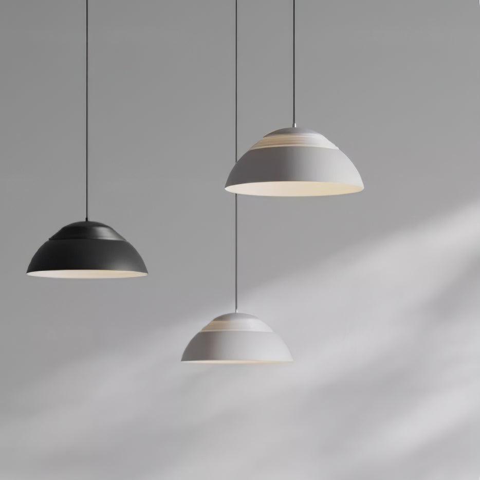 Vantara pendant light in matte black above a minimalist kitchen with dark cabinetry