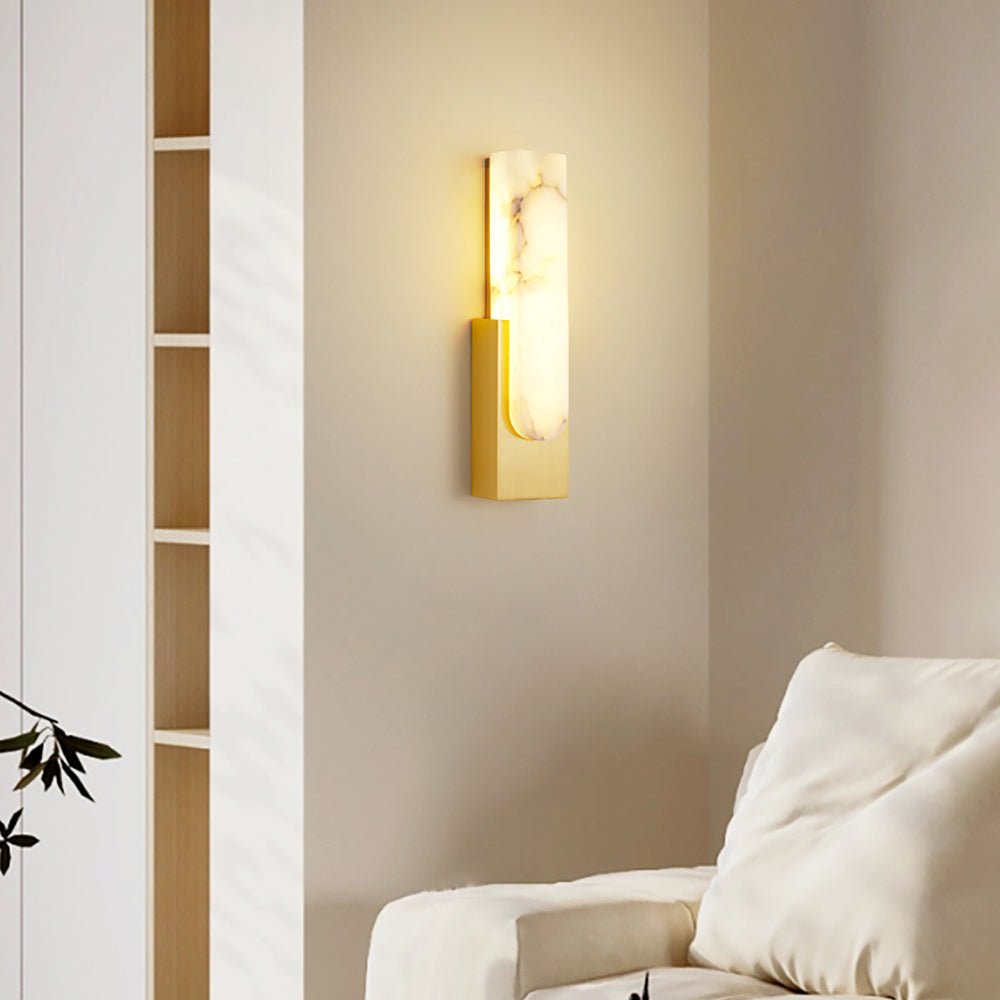 Iwara Wall Light lit, casting a warm soft glow through natural Iwara stone shade