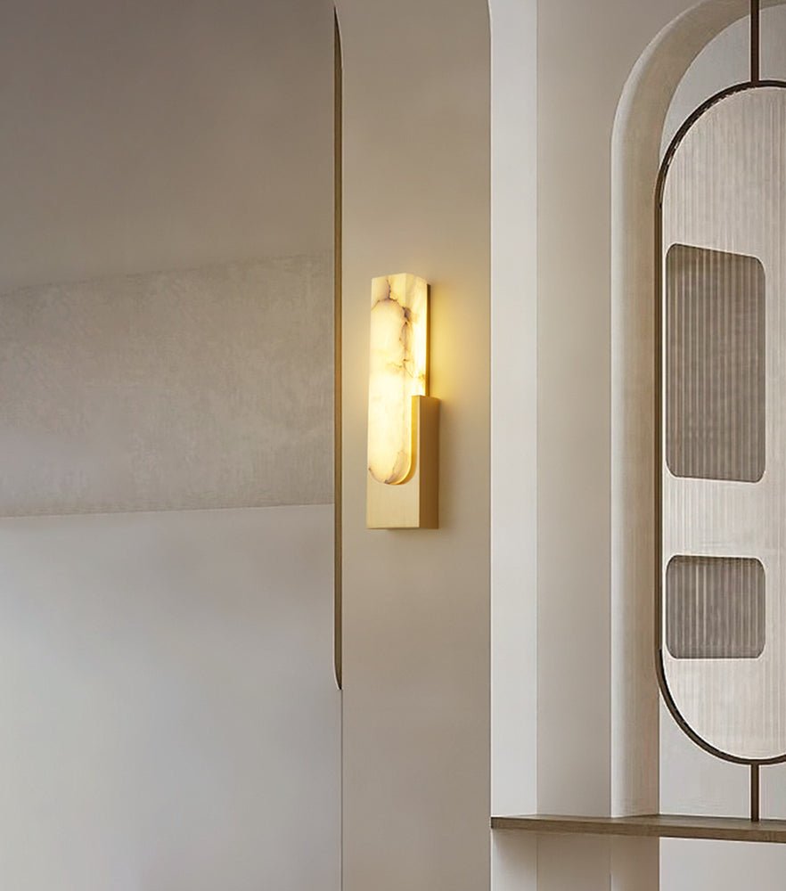 Side profile of Iwara Iwara Wall Sconce showing Iwara metal arm and stone shade proportions