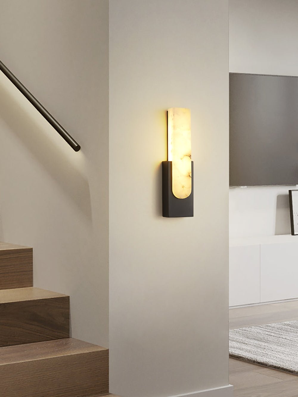 Iwara Iwara Wall Light mounted in a hallway, natural stone shade glowing softly