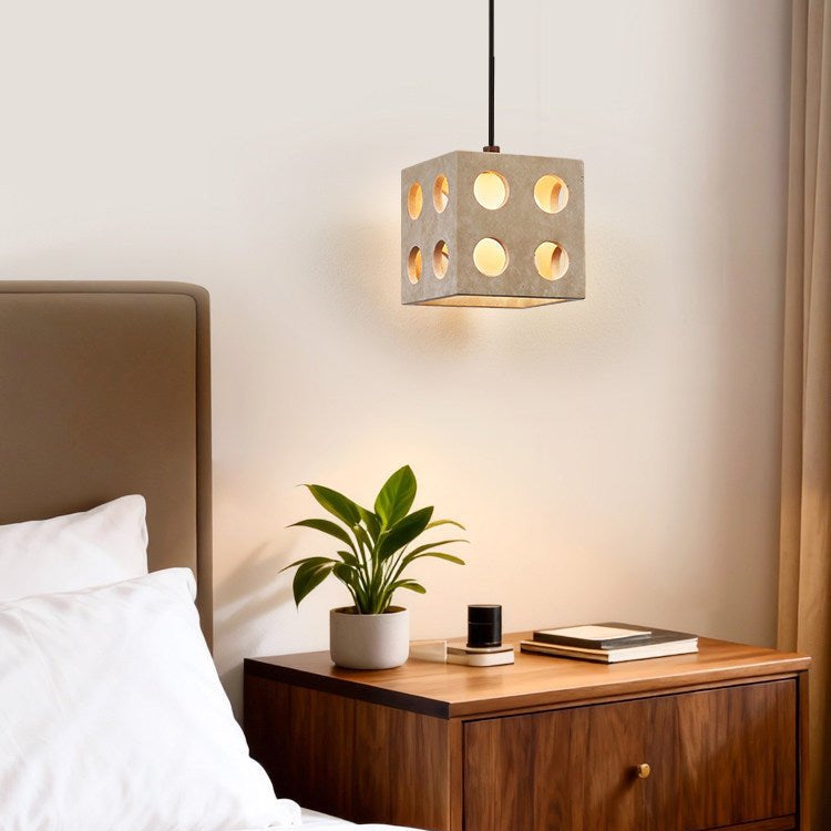 Kiru travertine pendant light shown from below revealing diffused glow through stone cutouts
