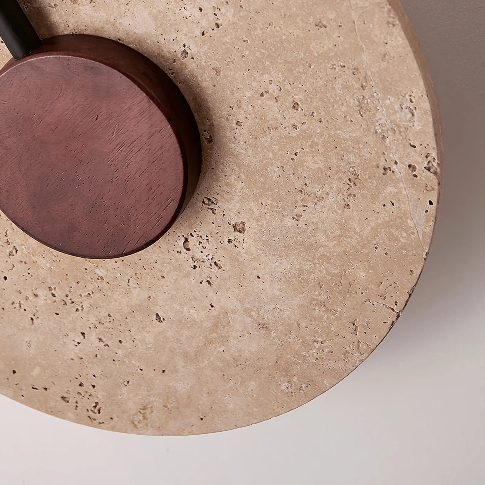 Tovi travertine wall light installed in a dining room alongside natural material decor