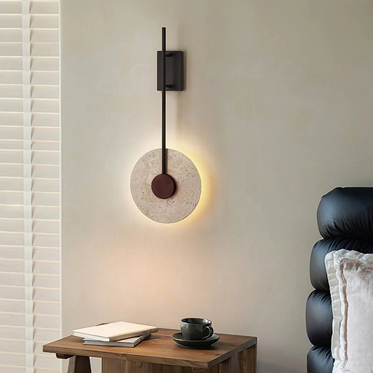 Tovi travertine wall light in a calm, natural interior with linen and wood tones