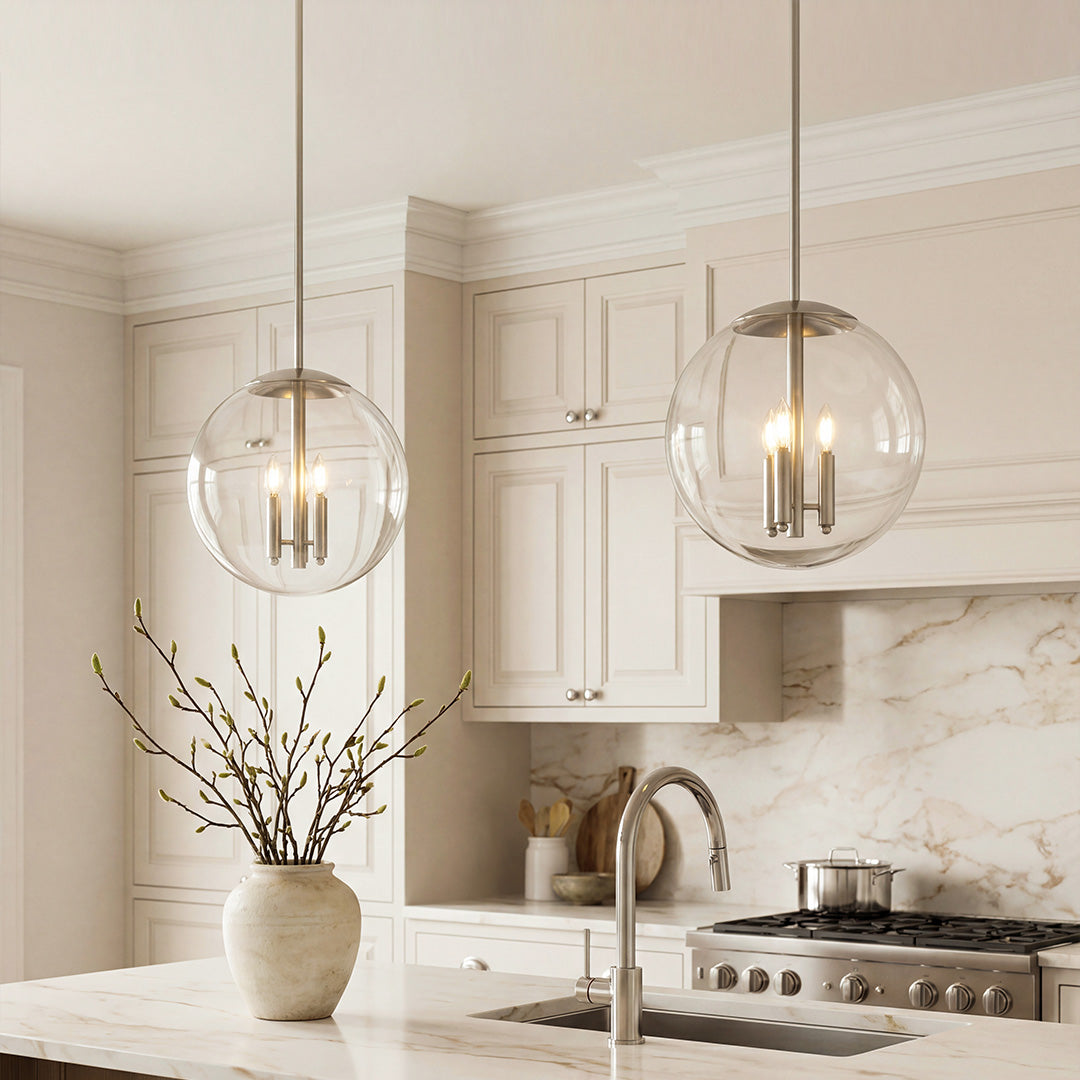 Aureon clear glass orb pendant light with polished silver metal frame on white background
