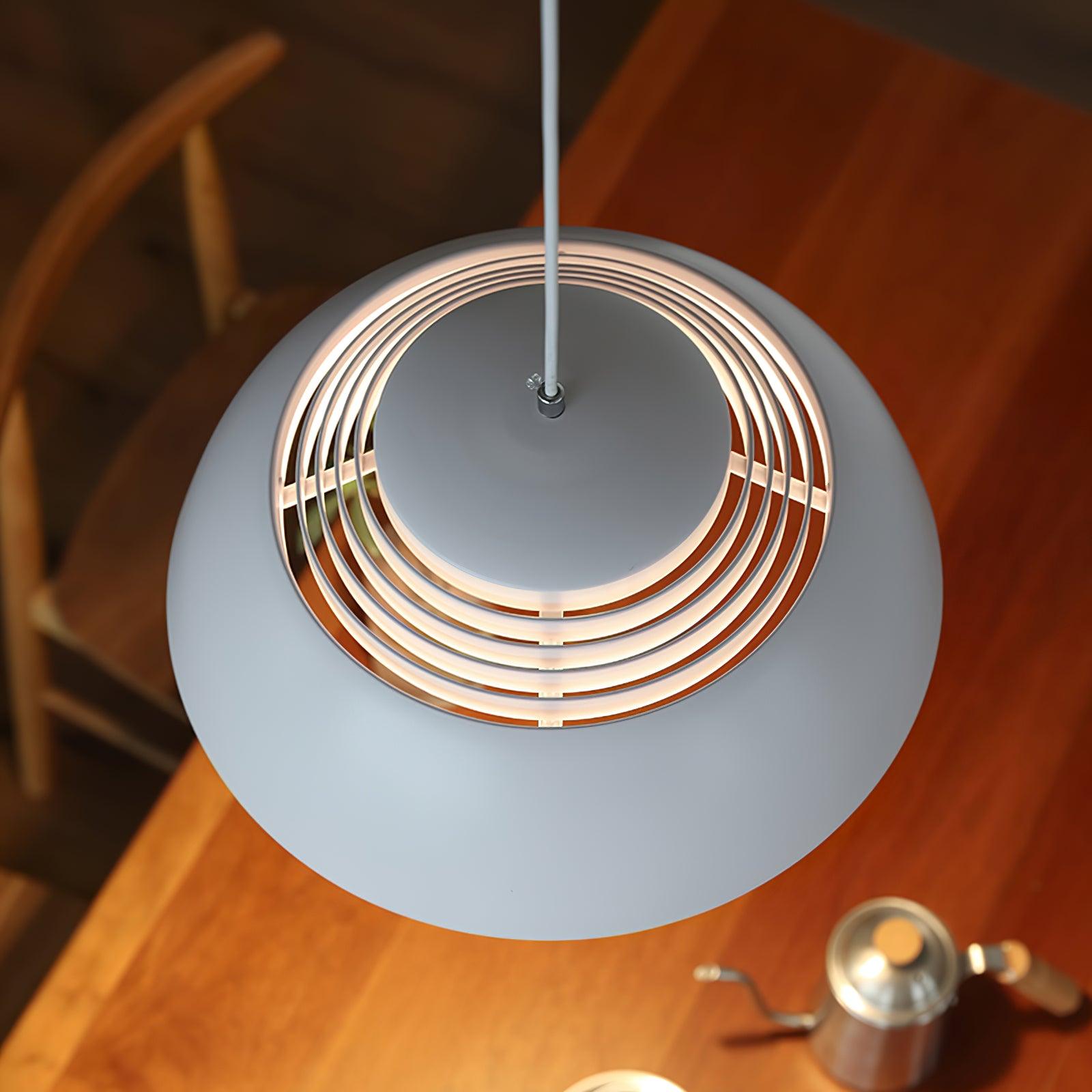 Vantara pendant light in matte white installed in a bedroom as a bedside overhead light