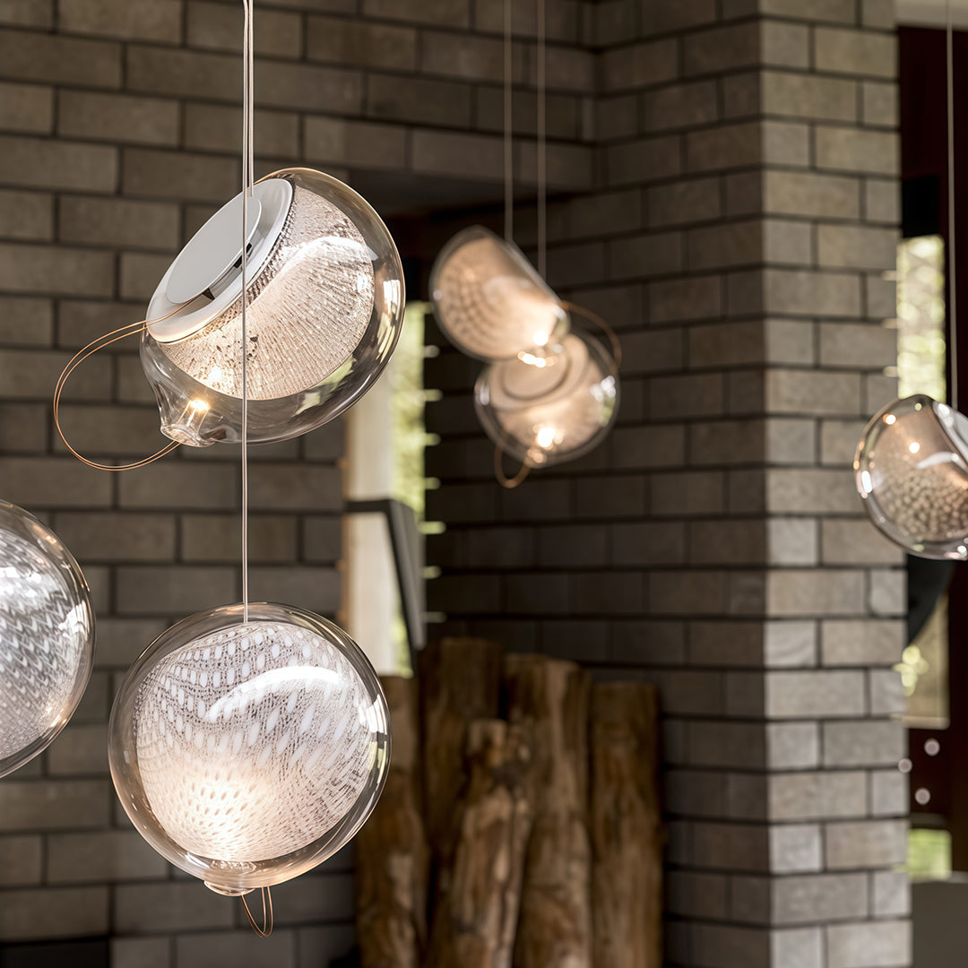 Amber-toned jellyfish glass pendant light with warm G4 illumination in a modern living space