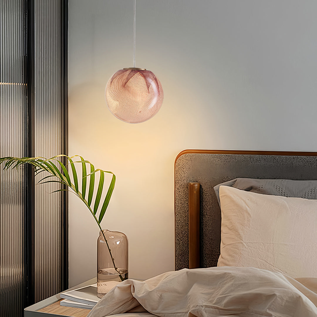 Rose gold glass globe pendant light in a bedroom with warm ambient lighting