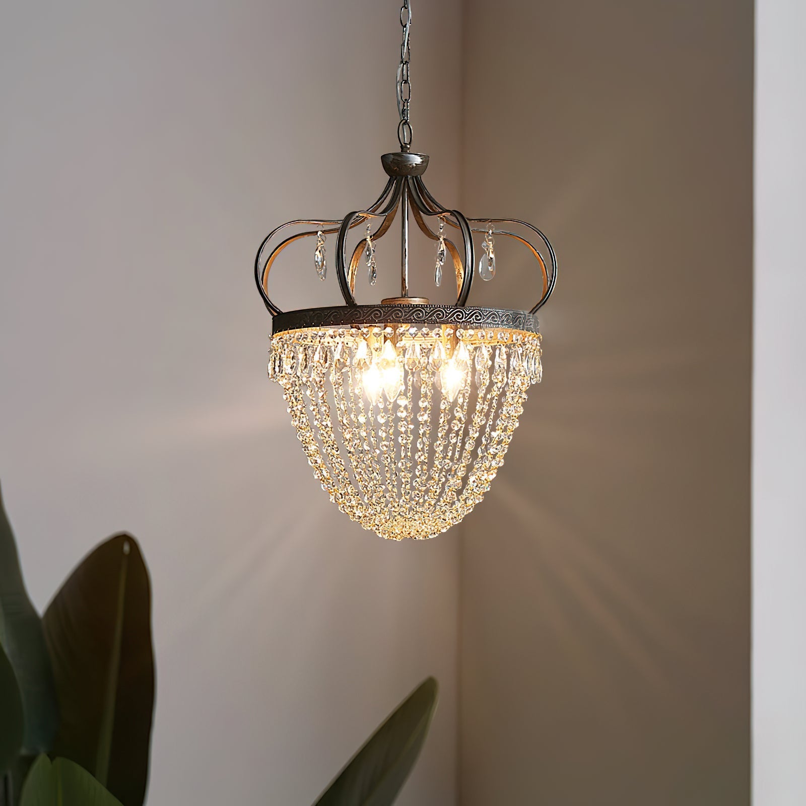 Vantara chandelier small size shown in a bedroom above a bedside area