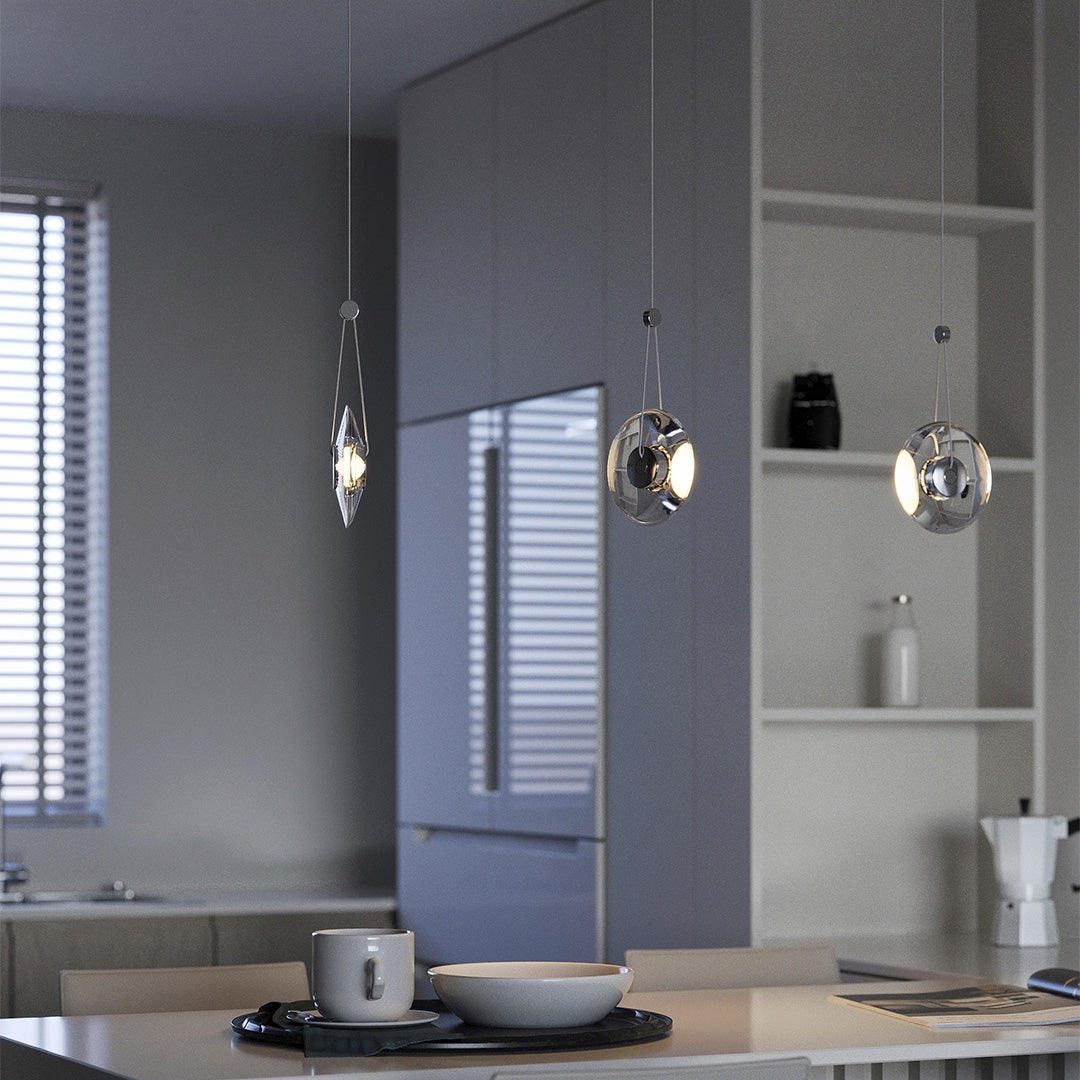 Aureon transparent crystal pendant light over a dining table in a minimalist dining room