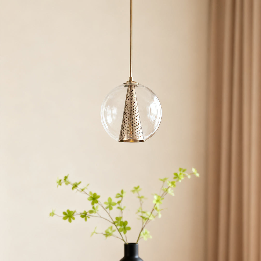 Close-up of perforated metal cone detail on the Aureon clear glass pendant light