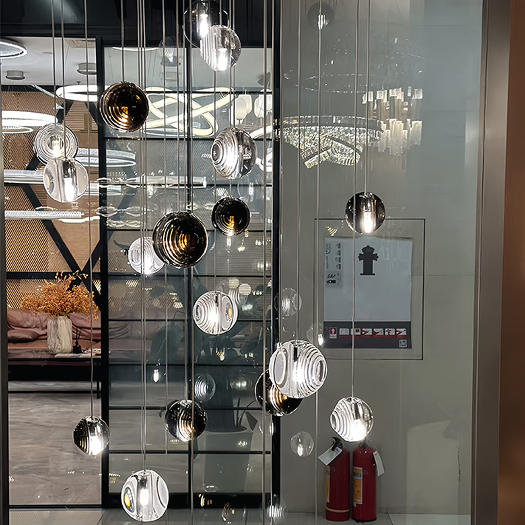 Cluster of Aureon transparent smoked glass sphere pendant lights in a modern retail display