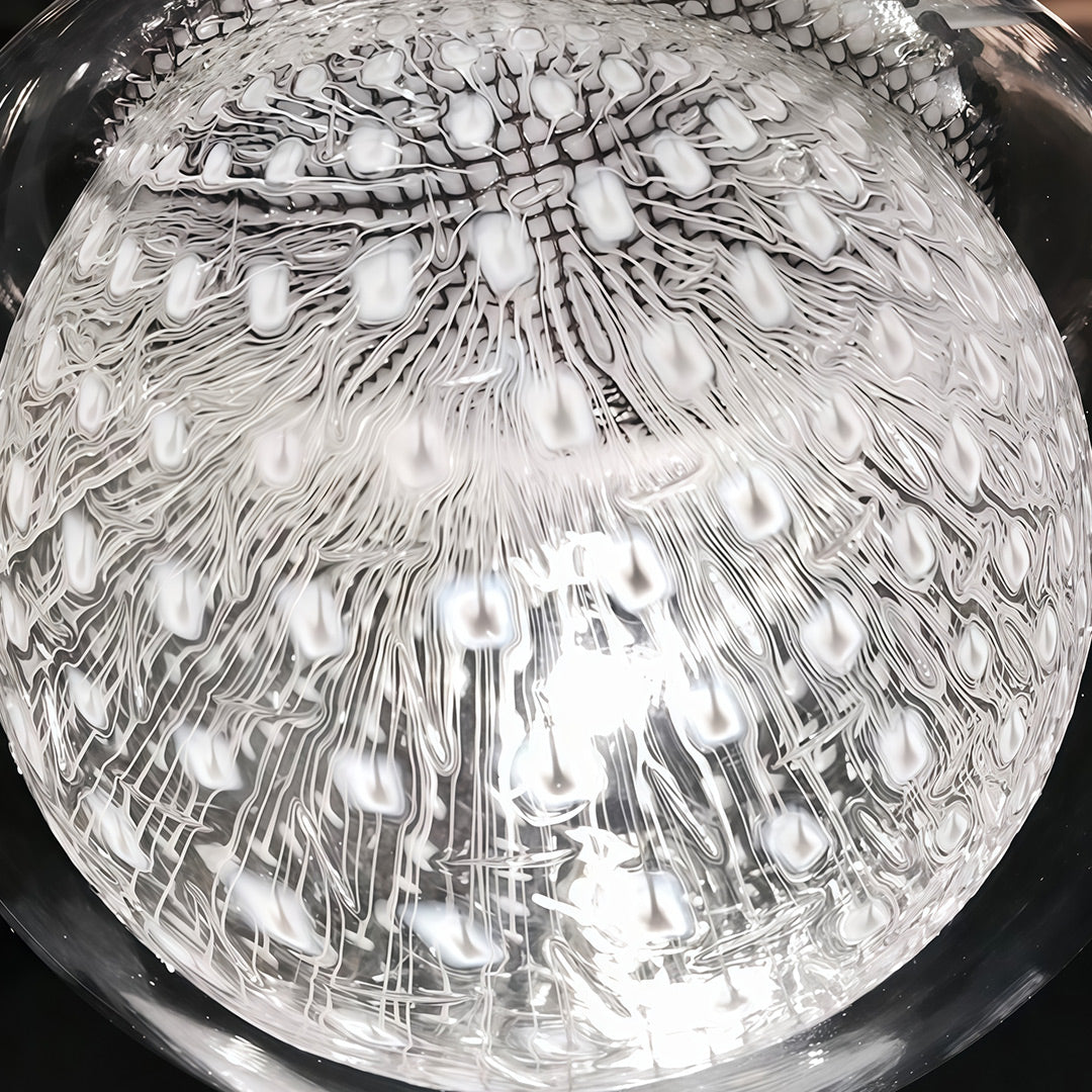 Close-up of Aureon jellyfish glass pendant light shade, clear glass with warm G4 light source