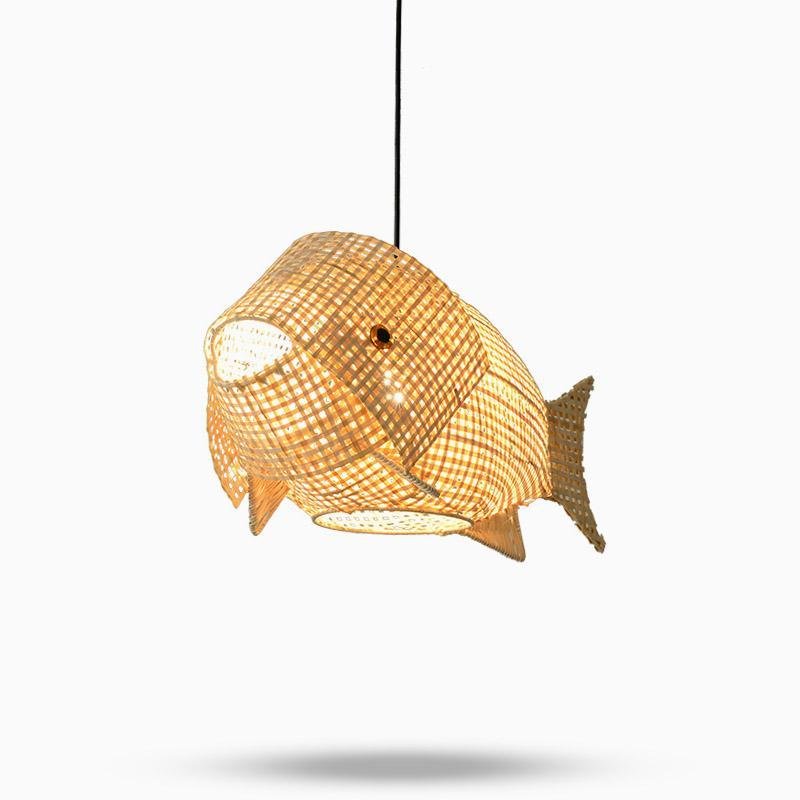 Woven bamboo fish pendant light above a minimalist dining table
