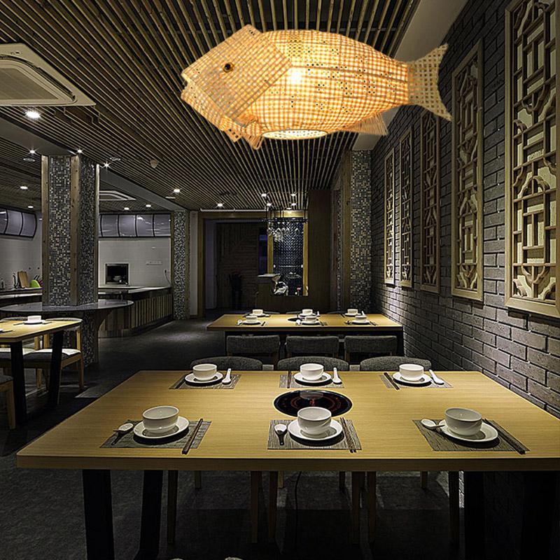 Fish-shaped woven bamboo ceiling light in a modern restaurant interior