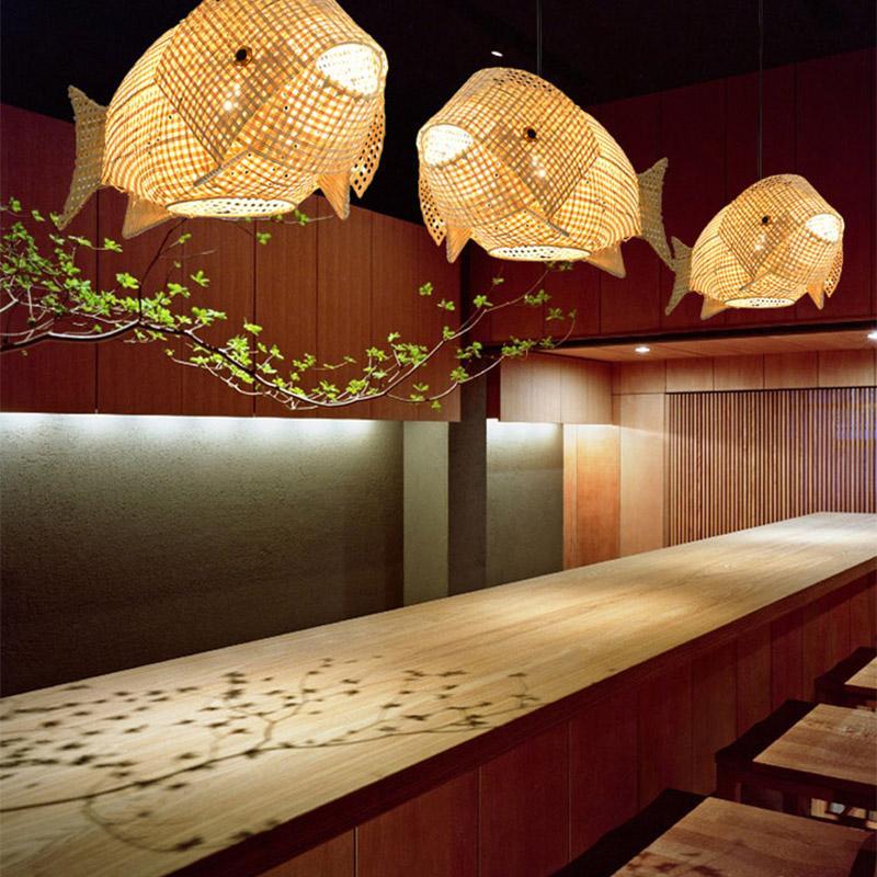 Handwoven bamboo pendant light casting warm light in a stylish dining room