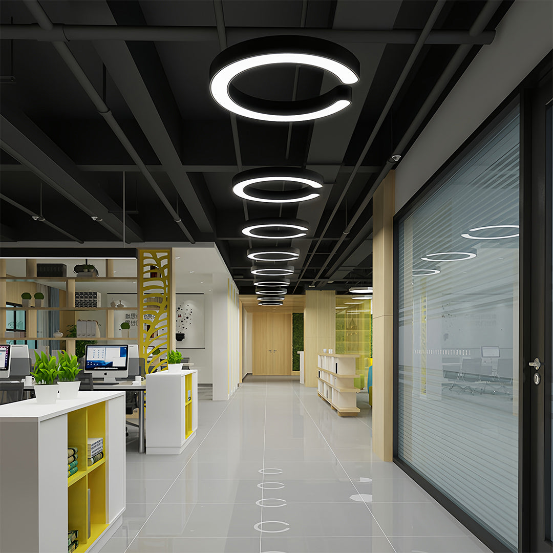 Multiple Aureon geometric pendant lights in a commercial hallway ceiling installation