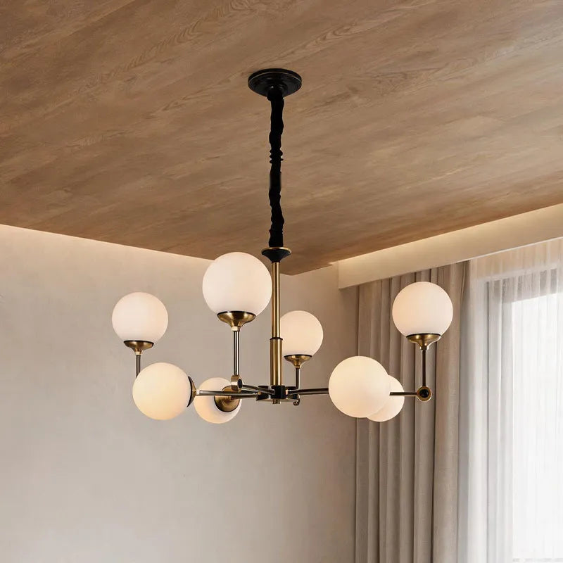 Auréline glass ball chandelier installed in a modern living room with high ceilings