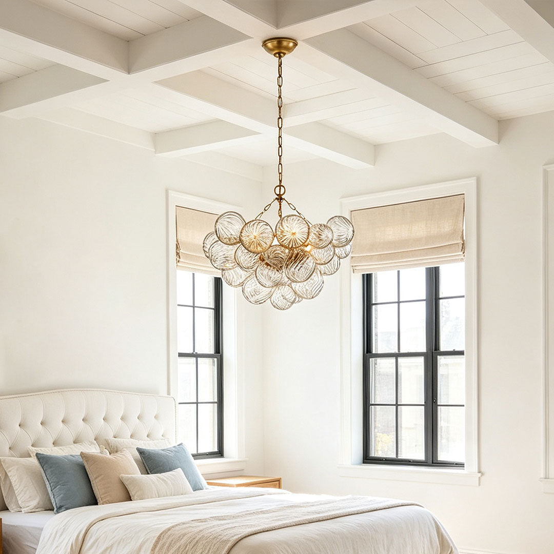 Auréline glass chandelier above a bed in a modern bedroom interior