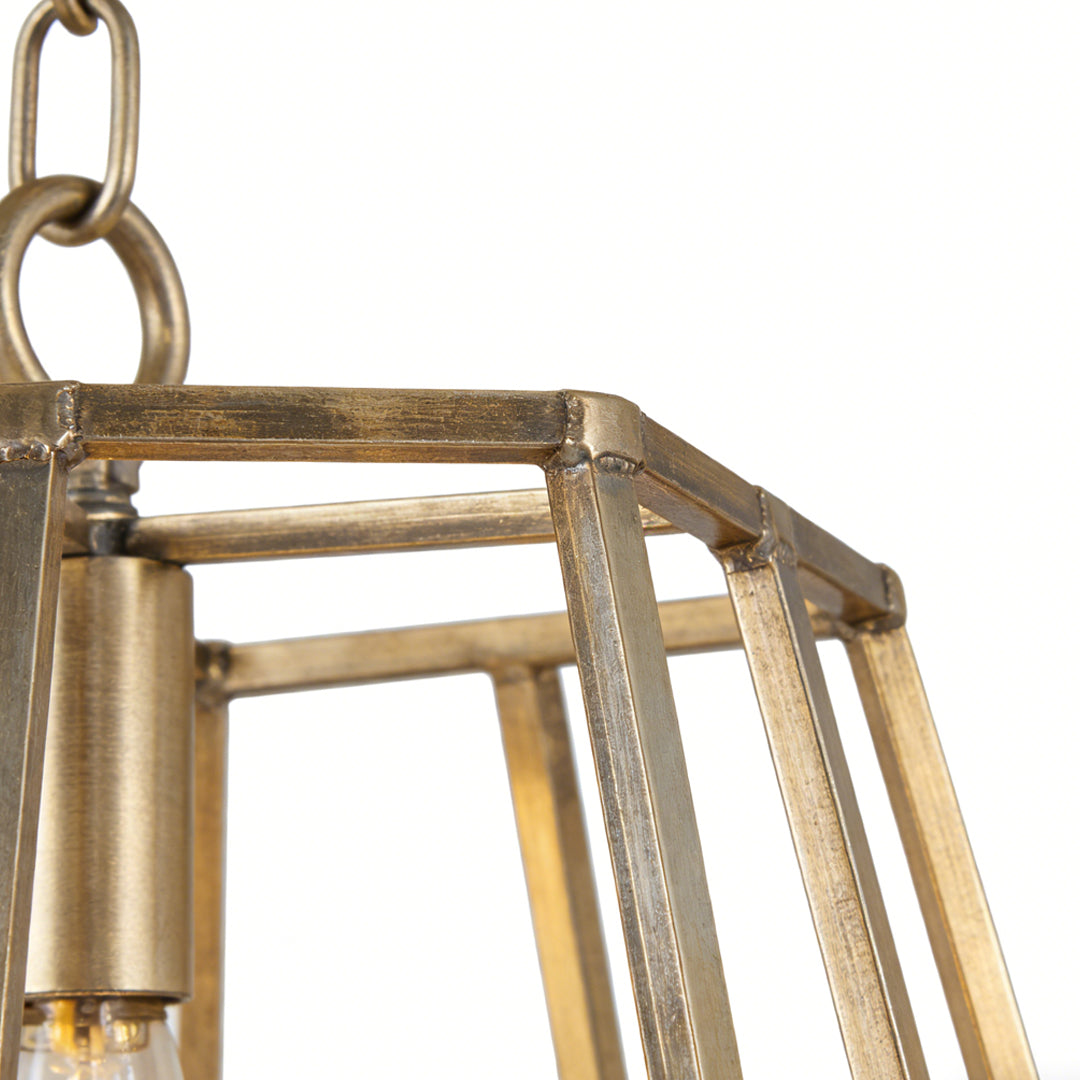 Aureon gold geometric cage pendant light close-up showing cylindrical bulb holder and open frame