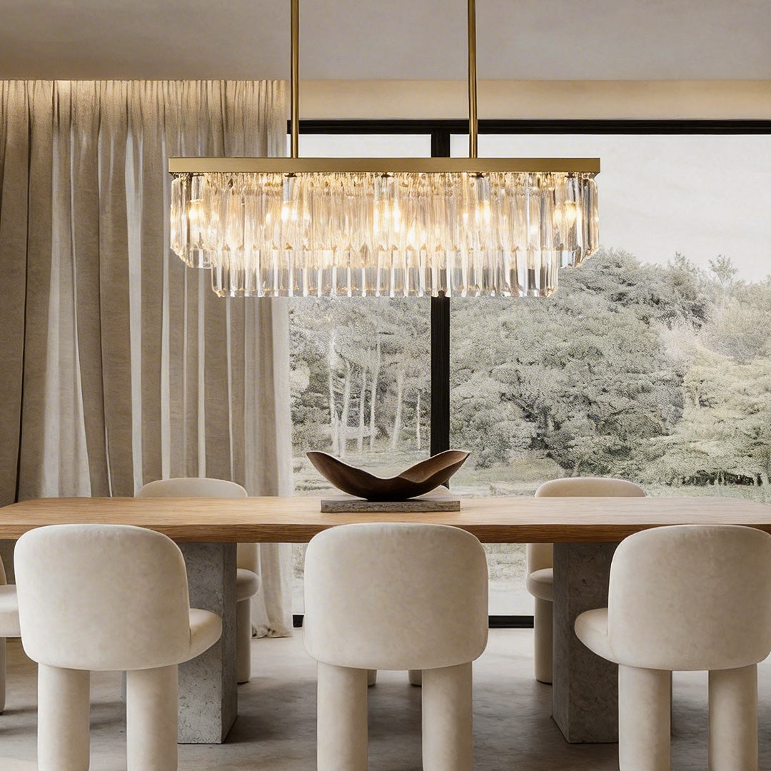 Modern rectangular crystal chandelier in a contemporary dining room with gold frame