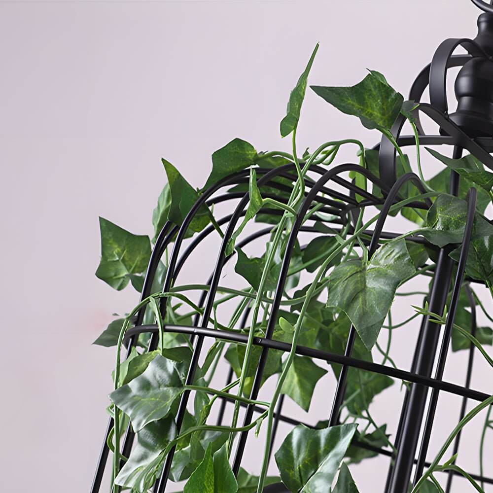 Close-up of Aureon pendant light lush artificial leaves and candle-style LED glow
