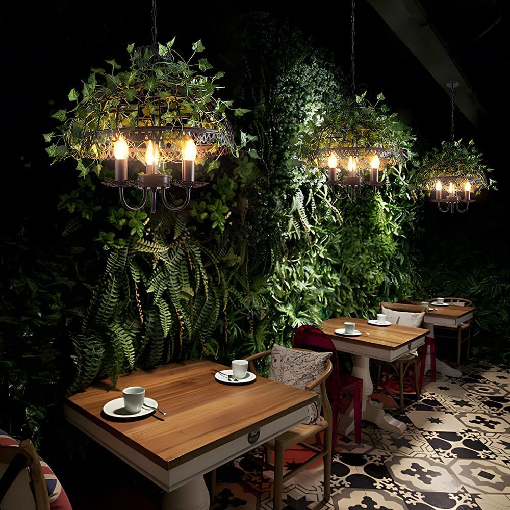 Aureon pendant light with vine detail casting soft warm illumination in an event venue