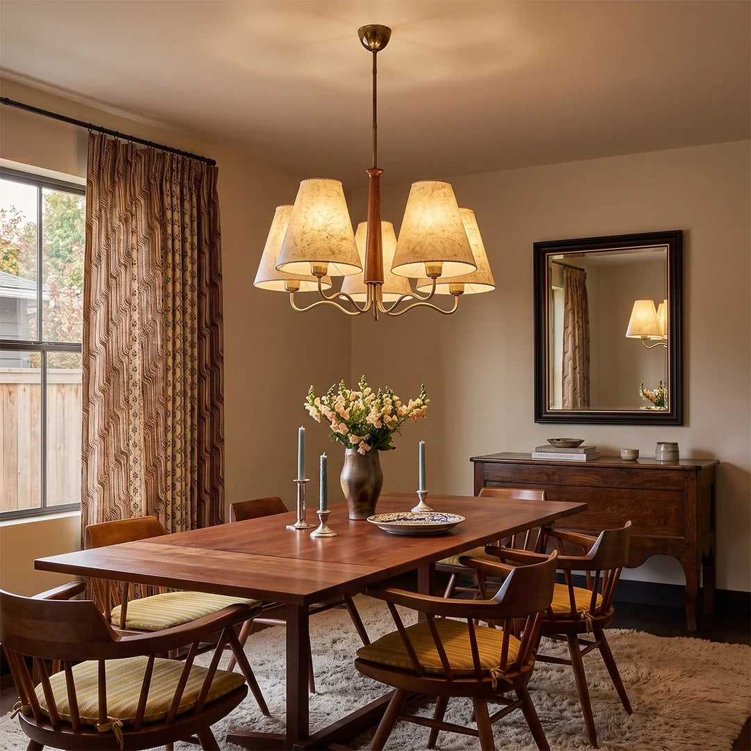 Auréline chandelier with walnut wood finish above a wood dining table, fabric parchment lampshades