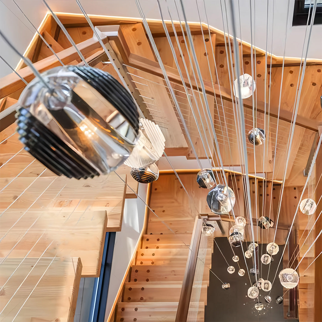 Aureon smoked glass pendant lights in a multi-level staggered arrangement over a staircase