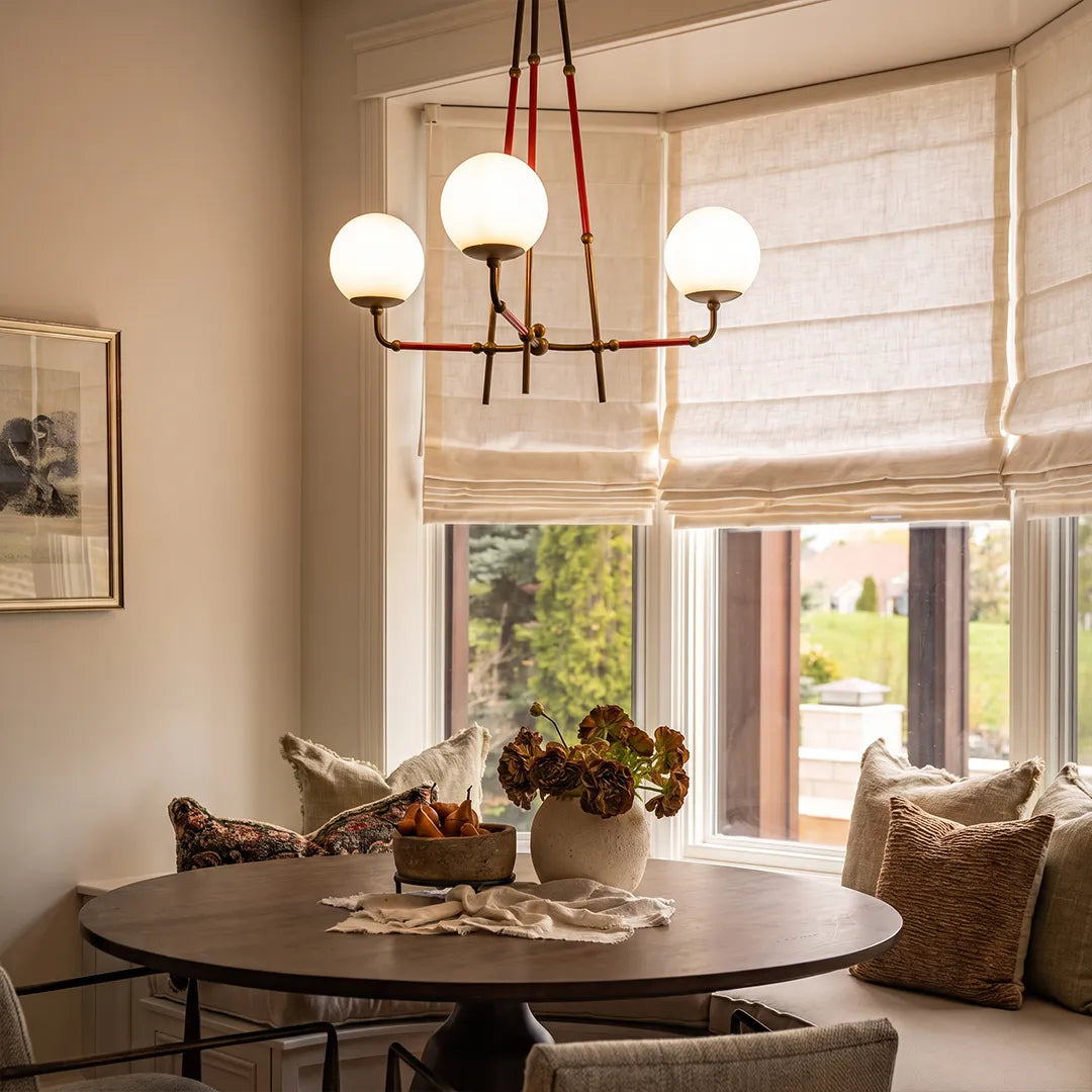 Auréline copper chandelier with white glass shades above a round dining table