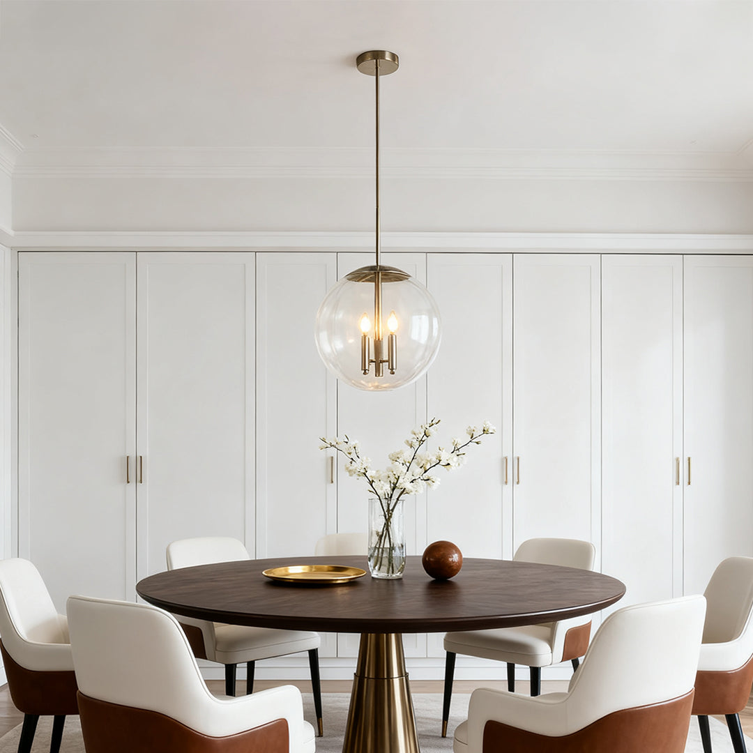 Aureon glass globe pendant light above a round dining table in a minimalist white room