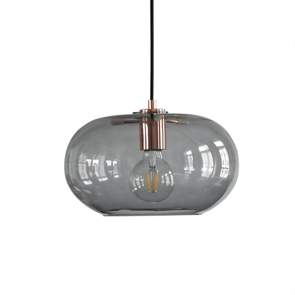 Aureon pendant light in amber glass shade showing warm light diffusion through the shade
