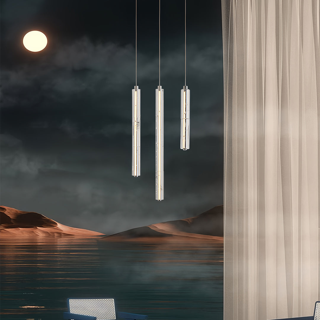 Aureon cylindrical crystal pendant light above a bed in a modern luxury bedroom