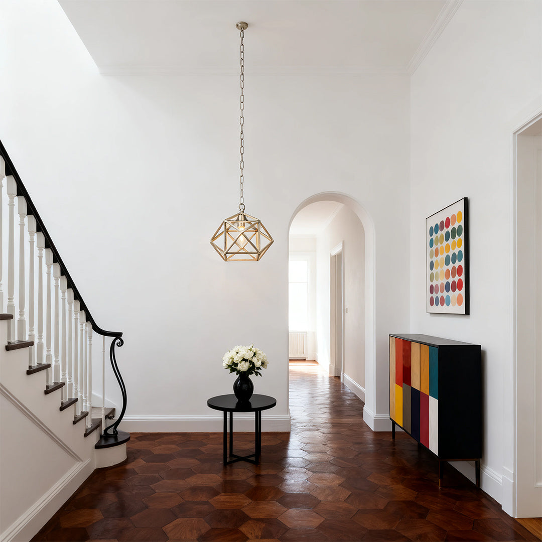 Aureon gold geometric open-cage pendant light hanging in a modern foyer entryway