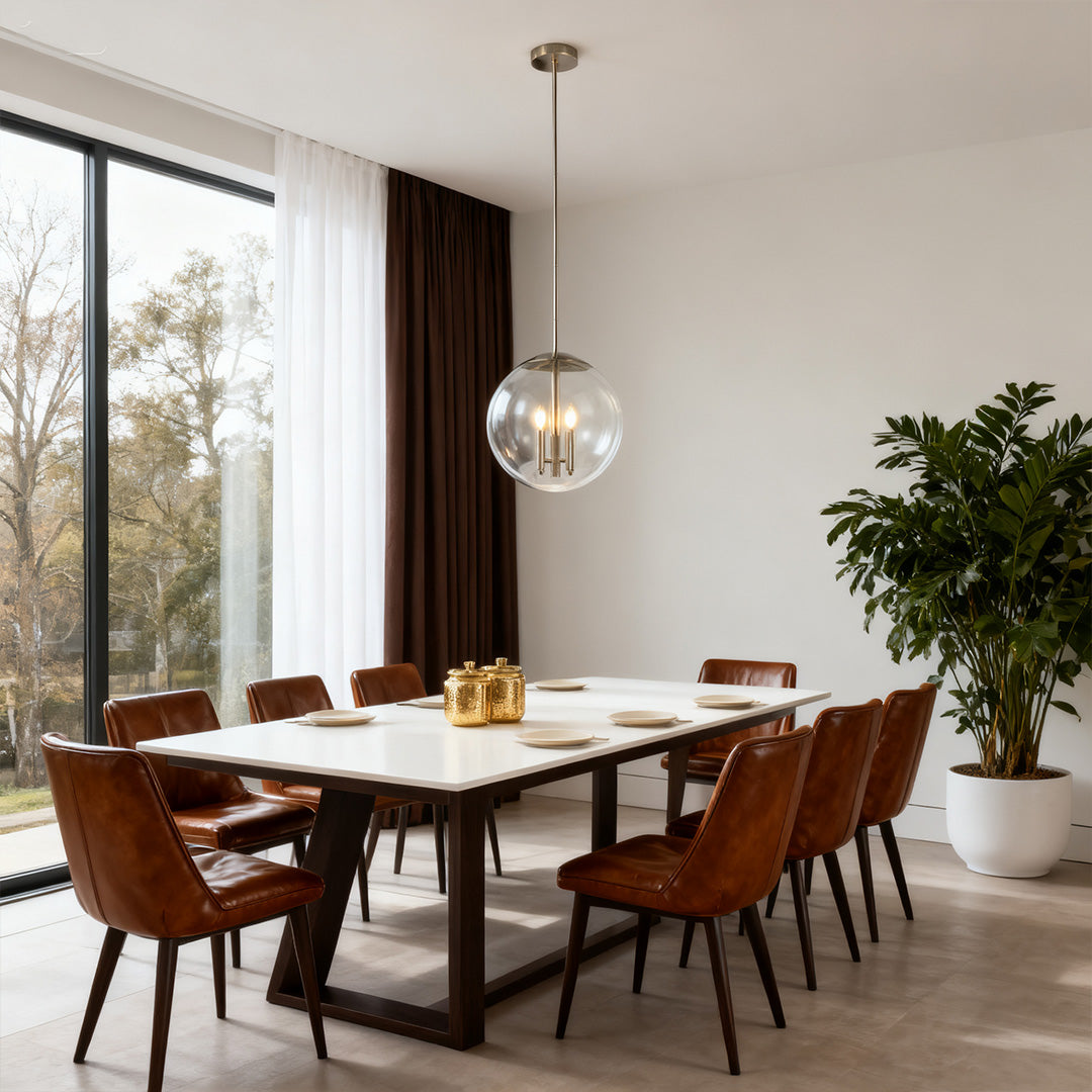 Aureon glass orb pendant light above a dining table with leather chairs and natural window light