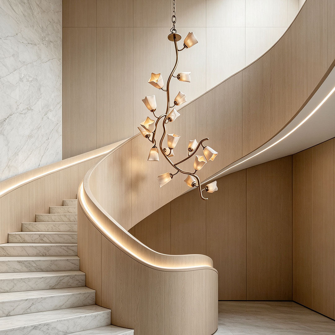 Auréline stainless steel and glass chandelier beside a curved modern staircase