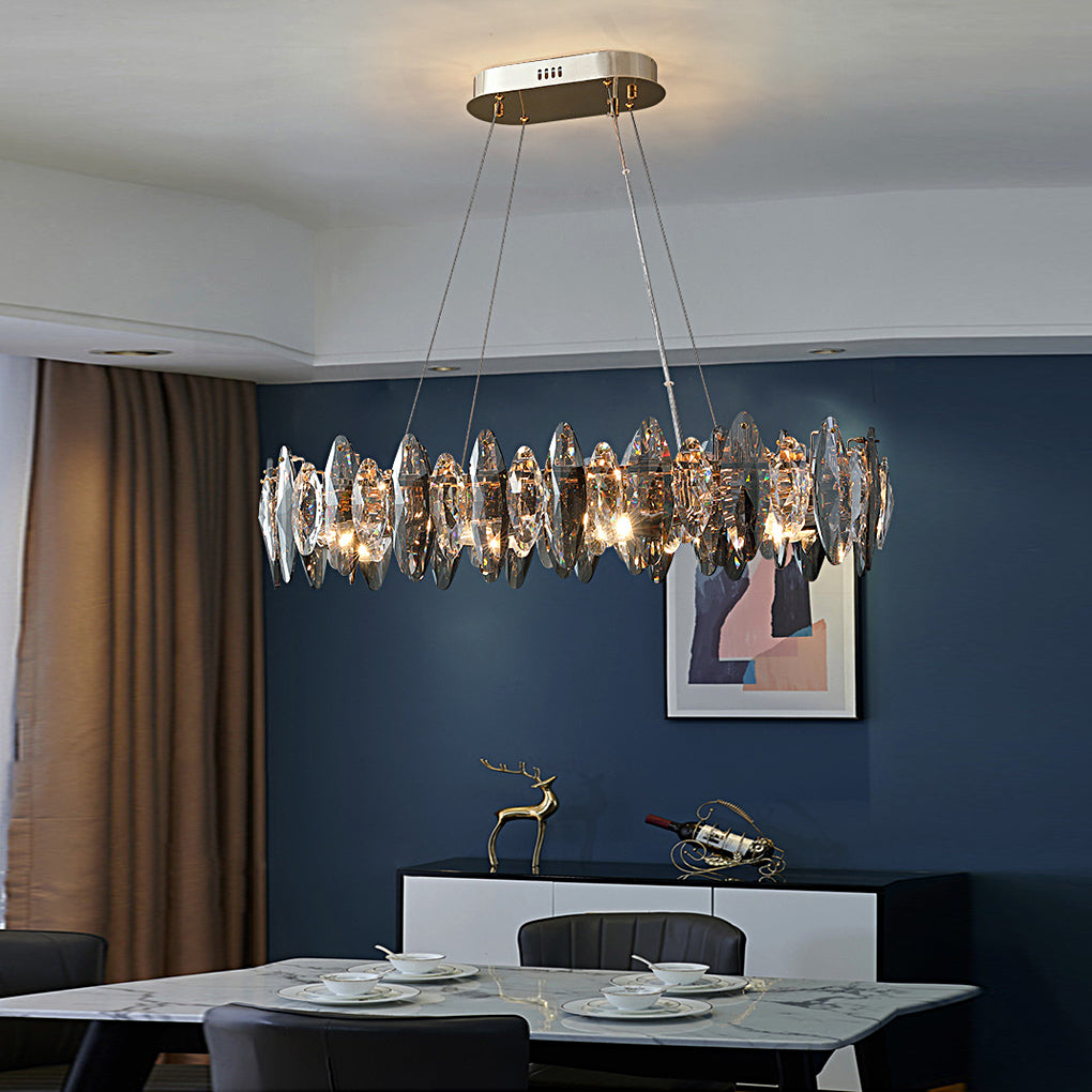 Oval crystal ring chandelier with smoky glass pendants above a contemporary dining table