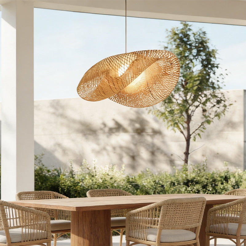 Natural rattan pendant light above an outdoor dining area