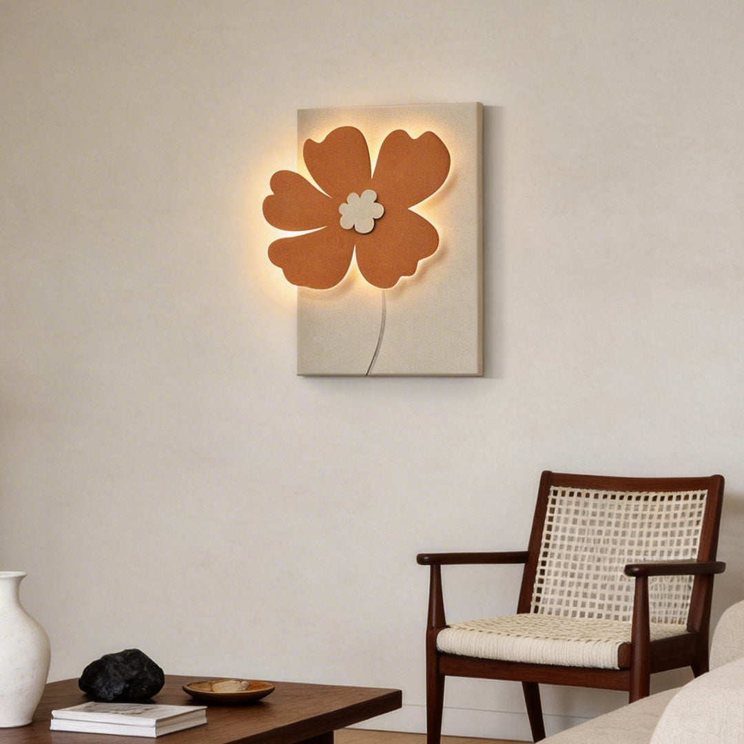 Floral relief LED wall light above a modern armchair in a contemporary interior