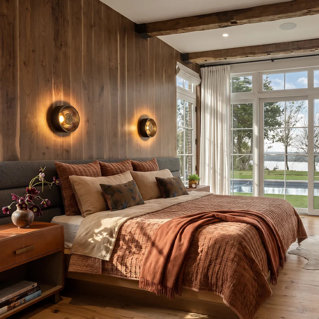 Niva wall sconce mounted on a wood-panelled bedroom wall, warm LED glow illuminated