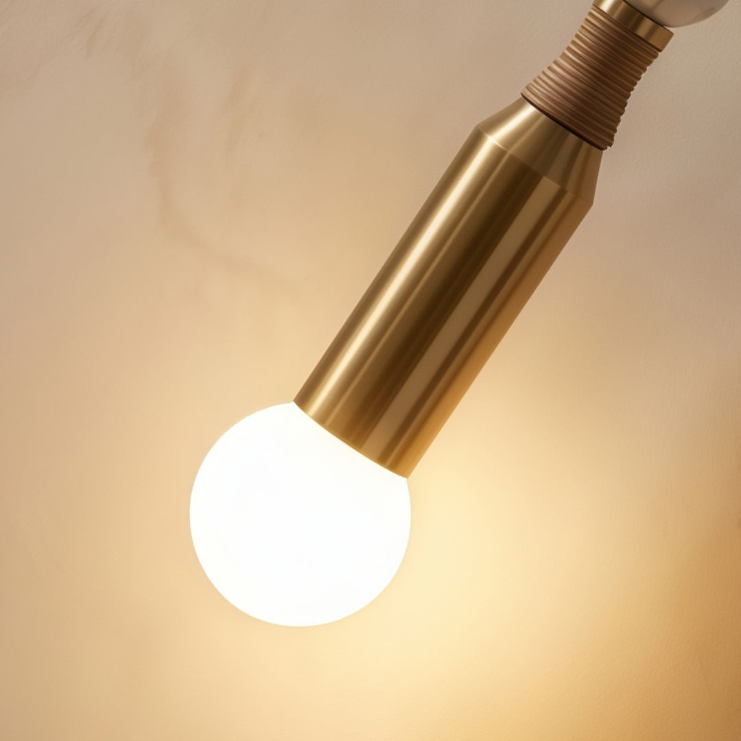 Close-up of Alure globe wall light E27 bulb and marble-effect acrylic shade, copper iron arm detail