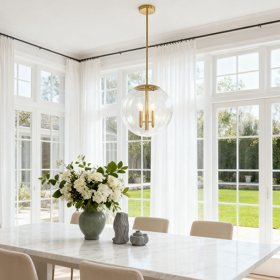 Single Aureon clear globe pendant light in a bright modern dining room
