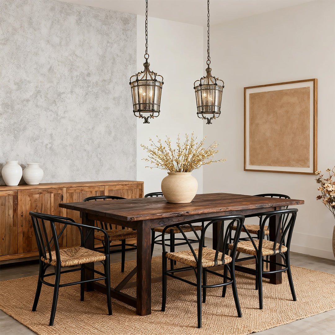 Single gothic lantern iron pendant light over a formal dining table with dark wood panelling and distressed plaster walls