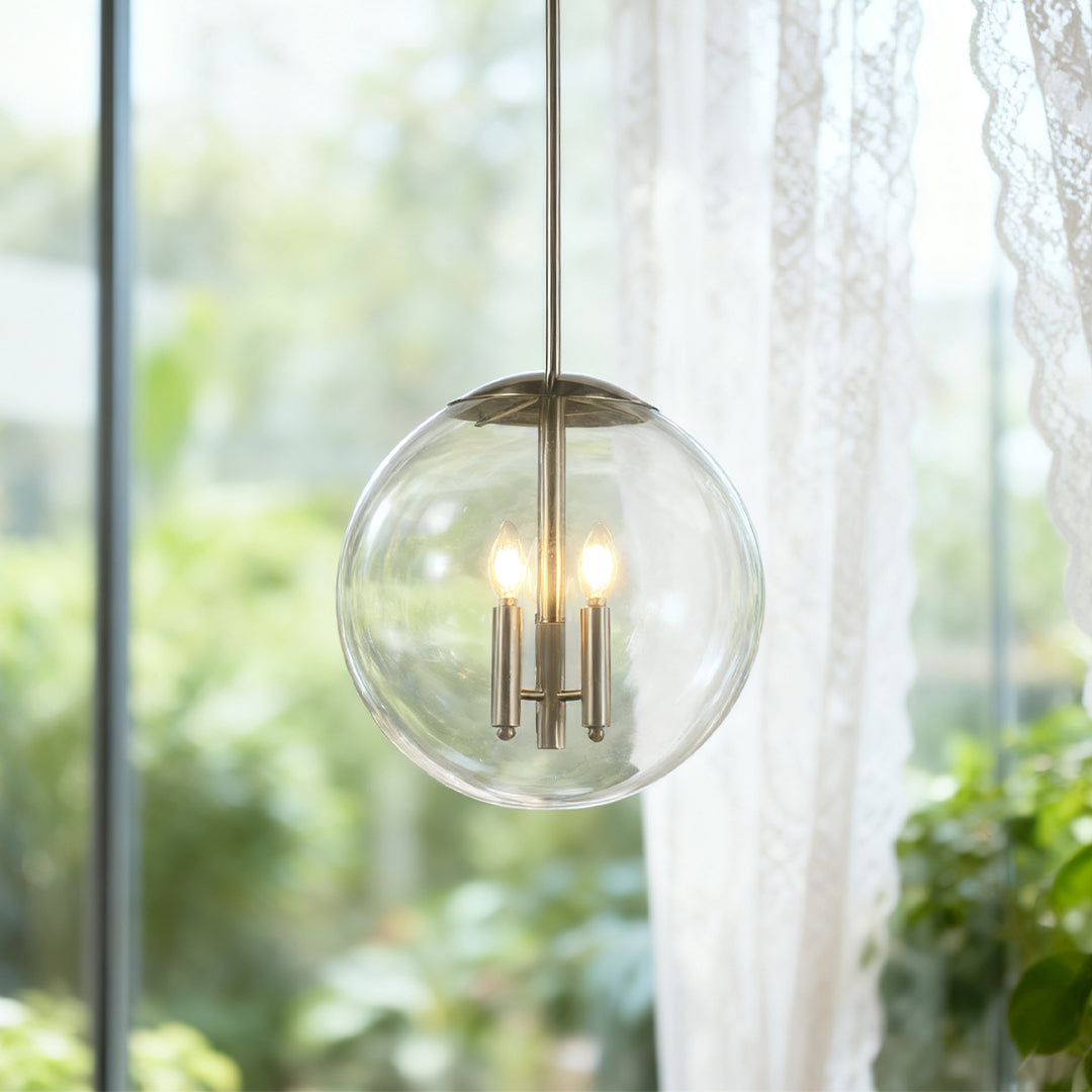 Single Aureon silver pendant light against a window in a contemporary interior