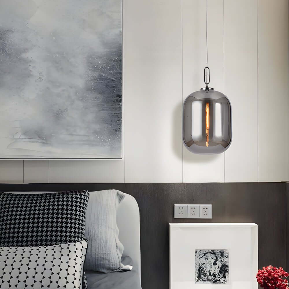 Aureon smoke gray glass pendant light in a contemporary bedroom setting