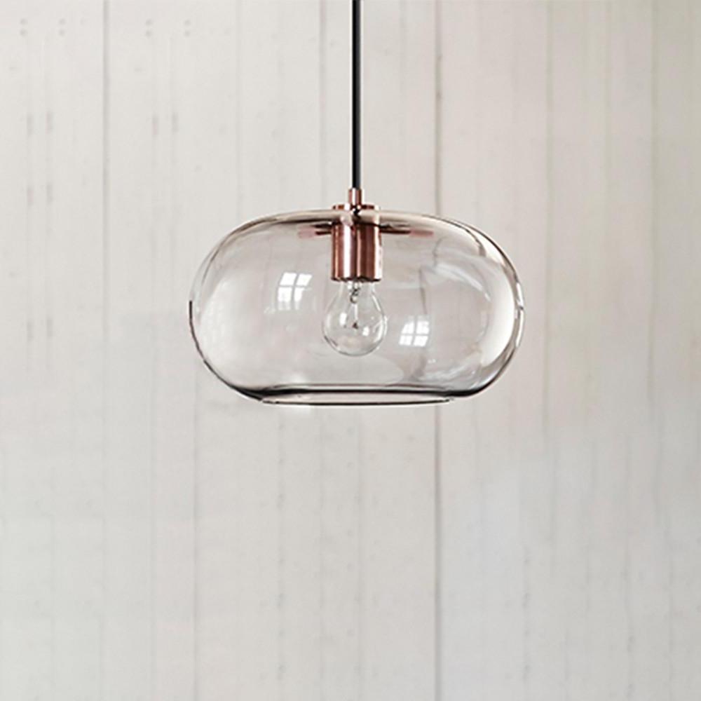 Aureon glass pendant light installed in a modern living room, ambient lighting