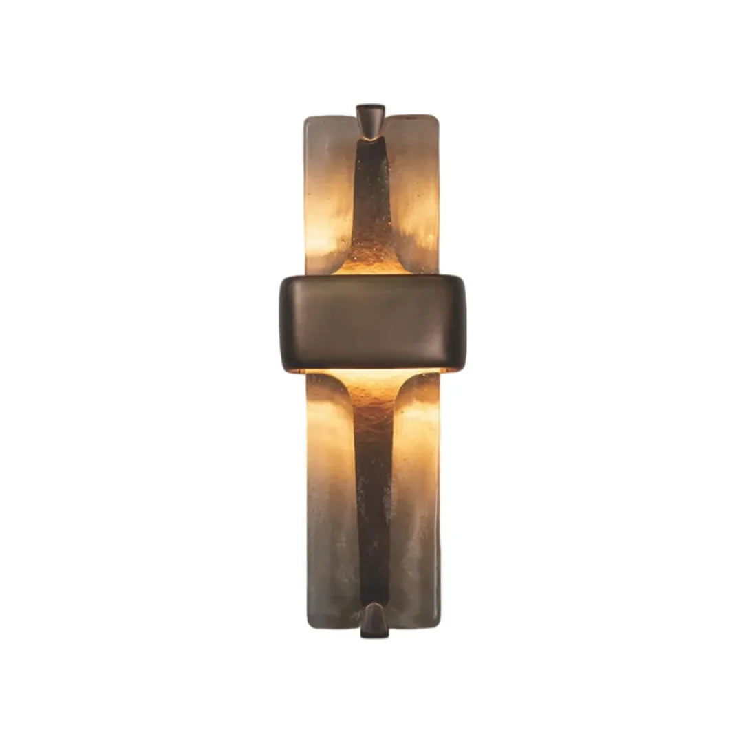 Niva resin wall sconce lit, warm LED glow on textured surface, black finish