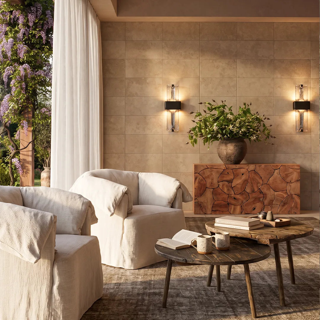 Niva decorative wall light beside a stone fireplace, gold finish, warm glow